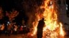 People attend the traditional annual bonfire of dried oak branches to celebrate Orthodox Christmas Eve, in front of a cathedral in Podgorica, Montenegro, on January 6.&nbsp;