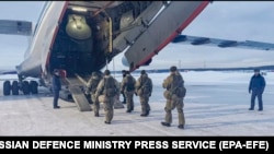 Russian servicemen board a military aircraft on their way to Kazakhstan, at an airfield outside Moscow on January 6. 