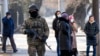 A Kazakh soldier patrols an Almaty street following deadly protests that rocked the city at the start of the year. 