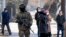 A Kazakh soldier patrols an Almaty street following deadly protests that rocked the city at the start of the year. 