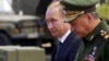 Russian President Vladimir Putin (left) and Defense Minister Sergei Shoigu. The EU said Shoigu was "ultimately responsible for any military action against Ukraine.”
