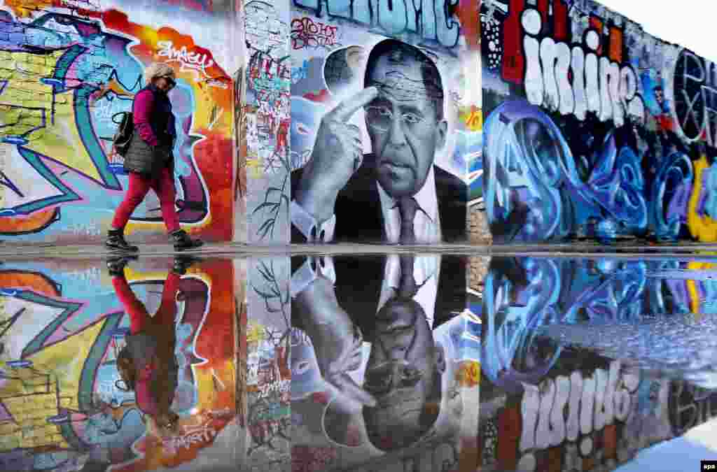 A woman walks by graffiti in Moscow depicting Russian Foreign Minister Sergei Lavrov by Russian artist Daniil Sudnev. Sudnev created the graffiti to mark Lavrov&#39;s 67th birthday. (epa/Yuri Kochetkov)