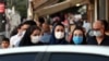 IRAN -- Iranians wearing face masks walk on a street of Tehran, September 24, 2020