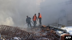 Emergency workers extinguish a fire at the site of an air strike that hit a building near the Iranian Embassy in Damascus on April 1. 