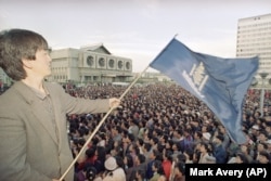 Një protestues duke valëvitur flamurin e Partisë Demokratike të Mongolisë në Ulan Bator. Korrik, 1990.