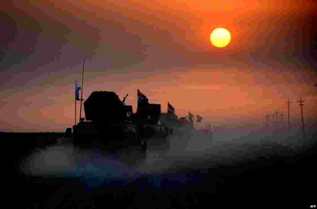 Pro-government forces drive in military vehicles in Iraq&#39;s eastern Salaheddin Province, south of Hawijah. (AFP/Mahmoud al-Samarrai)