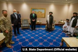 U.S. Secretary of State Mike Pompeo with the Taliban delegation in Doha on September 12.