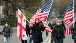 Demonstrators carry Georgian and US flags during an opposition rally in Tbilisi. (file photo)