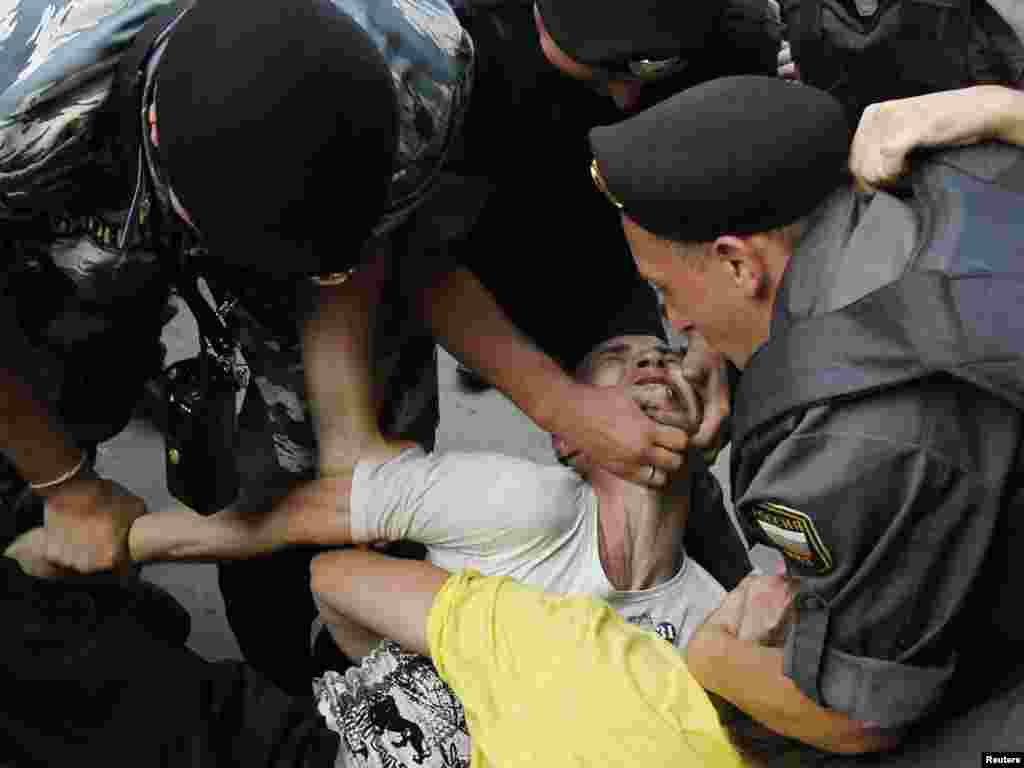 An activist is detained by police during a protest action to defend Article 31 of the Russian Constitution in Moscow. Article 31 guarantees the right of assembly.Photo by Denis Sinyakov for Reuters