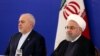 FILE - Iranian President Hassan Rohani (R) and his top diplomat, Mohammad Javad Zarif, attend a meeting with the staff of the Islamic republic's foreign ministry in Tehran, August 6, 2019