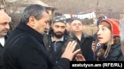 Armenia - Video screenshot of Syunik Governor Surik Khachatrian (L) arguing with Mariam Sukhudian (R) and other environmental activists in Kajaran village, 18Dec2011.