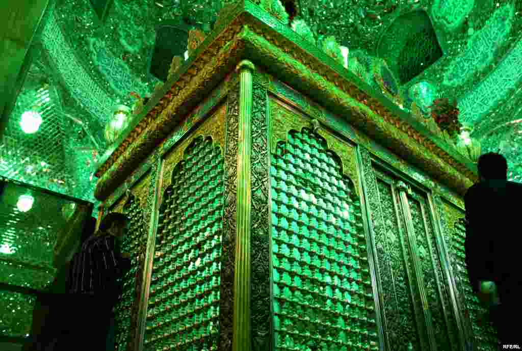 The elaborate mausoleum of an imam's son contrasts starkly with the run-down buildings and shuttered workshops outside.