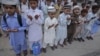 Pakistan -- Students of a madrasa (religious school) pray before going into a classroom at Karachi's Memon Mosque, 24Jun2012