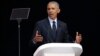 Former U.S. President Barack Obama, left, delivers his speech at the 16th Annual Nelson Mandela Lecture at the Wanderers Stadium in Johannesburg, South Africa, Tuesday, July 17, 2018.