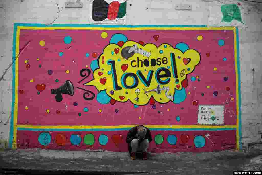 A migrant sits in front of a mural inside the Bira camp in Bihac, Bosnia-Herzegovina. (Reuters/Marko Djurica)