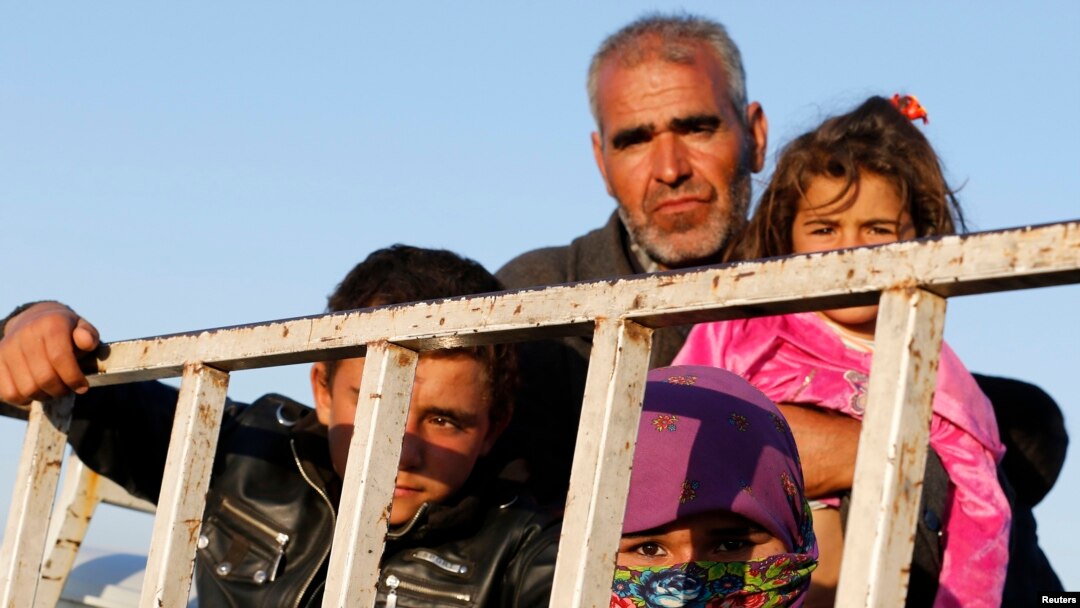 Newly arrived Syrian Kurdish refugees stand at the back of a truck after crossing into Turkey from the Syrian border town Kobani on October 6. 
