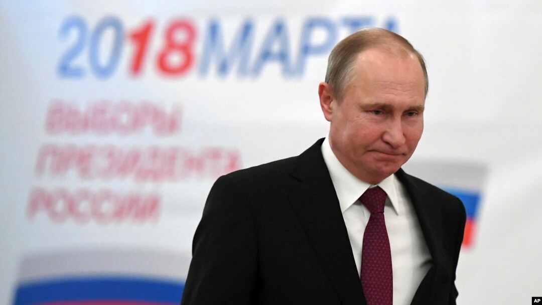Russian President Vladimir Putin arrives to vote at a polling station in Moscow on March 18.