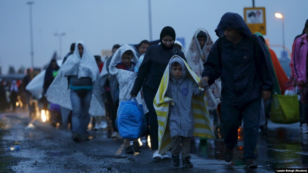 Migrants arrive at the Austrian-Hungarian border station of Hegyeshalom, Hungary, late on September 5.