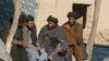 Afghan men in the town of Musa Qala shortly after the town was retaken by coalition troops in Decemb