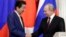 Japanese Prime Minister Shinzo Abe (left) and Russian President Vladimir Putin shake hands after a joint press statement following their meeting at the Kremlin in Moscow on January 22.