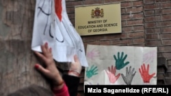Hands off: a recent protest outside the Georgian Education Ministry