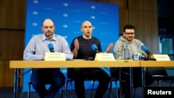 Russian activists Vladimir Kara-Murza (left), Andrei Pivovarov (center), and Ilya Yashin hold a news conference in Bonn on August 2 following their release from Russian captivity the previous day. 
