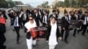 Lawyers display placards as they march along a street during an anti-France demonstration near the French Embassy in Islamabad on November 12.