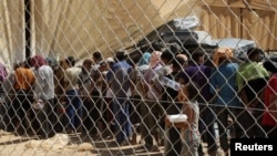 Syrian refugees wait to receive aid and rations at the Zaatri refugee camp in the city of Mafraq, Jordan, on September 5.