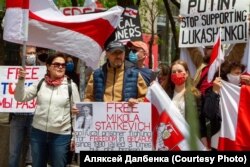 Alyaksey (center) and Maryya Dalbenka (to his right) at a Belarus solidarity rally in Canada.