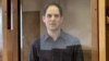 Evan Gershkovich stands inside the defendants' cage during a hearing on the extension of his pretrial detention at the Moscow City Court on March 26.