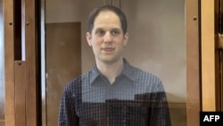 Evan Gershkovich stands inside the defendants' cage during a hearing on the extension of his pretrial detention at the Moscow City Court on March 26.