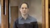 Evan Gershkovich stands inside the defendants' cage during a hearing on the extension of his pretrial detention at the Moscow City Court on March 26.