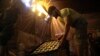 Vendors in Kabul prepare sweets on July 30 for the Eid al-Adha holiday, which is also the start of a three-day cease-fire.