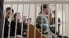 Election opponents of Belarusian President Alyaksandr Lukashenka sit in the dock in a Minsk courtroom on May 11