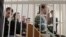 Election opponents of Belarusian President Alyaksandr Lukashenka sit in the dock in a Minsk courtroom on May 11