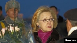 U.S. Secretary of State Hillary Clinton is welcomed upon her arrival in Astana on November 30.