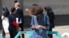 A man uses his mobile phone while standing at the Valiasr Square in Tehran on April 19, 2026.