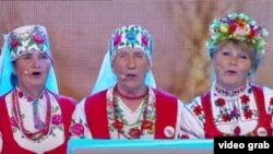 The Belarusian grannies extol Alyaksandr Lukashenka's prowess on the farm. "Lukashenka knows how to do everything, " they sing.