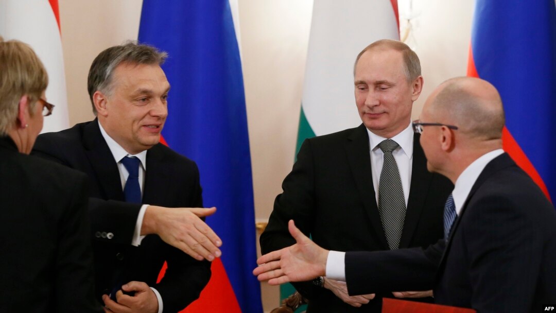 Russian President Vladimir Putin (2nd right) looks on as Hungary's Prime Minister Viktor Orban (left) shakes hands with Russia's nuclear agency Rosatom head Sergei Kiriyenko (right) during a meeting at the Novo-Ogaryovo residence outside Moscow on January 14.
