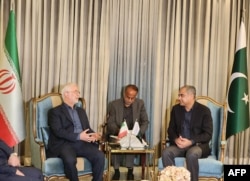 Pakistani Interior Minister Mohsin Naqvi (right) meets with his Iranian counterpart, Eskandar Momeni (left), at the Nur Khan airbase in Rawalpindi, Pakistan, on July 20.