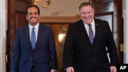 Secretary of State Mike Pompeo, right, walks with Qatari Foreign Minister Sheikh Mohammed bin Abdulrahman Al Thani, left, at the State Department, Wednesday, April 24, 2019 in Washington. (AP Photo/Pablo Martinez Monsivais)