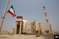 An Iranian flag flutters in front of the reactor building of the Bushehr nuclear power plant. (file photo)