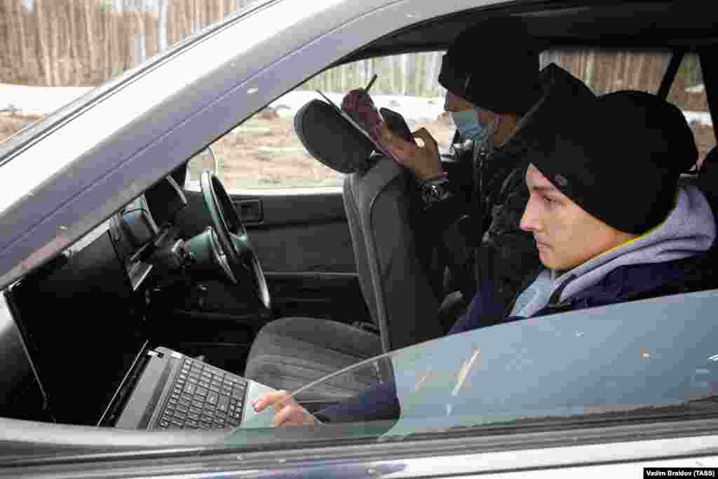 Russian students study on their laptops after they were driven out of their village near Chelyabinsk to a spot with a strong 3G signal.&nbsp; 