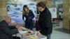 Armenia - A woman votes at a polling station in Yerevan, 6Dec2015.