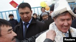 Дамир Мусакеев экс-президент Алмазбек Атамбаевдин артында.