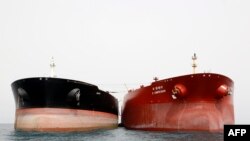 An Iranian tanker and a South Korean (R) tanker are docked at the platform of the oil facility in the Khark Island, on the shore of the Persian Gulf. File photo