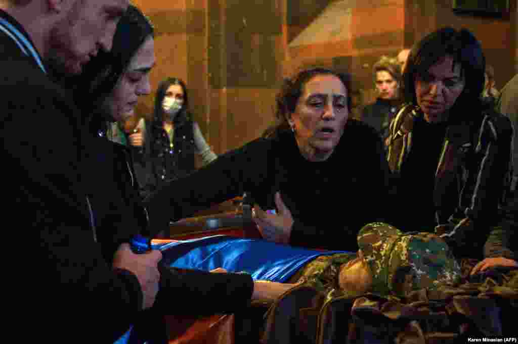 Relatives in Yerevan mourn by the coffin of a soldier killed in the fighting between Armenia and Azerbaijan over the breakaway region of Nagorno-Karabakh. (AFP/Karen Minasyan)