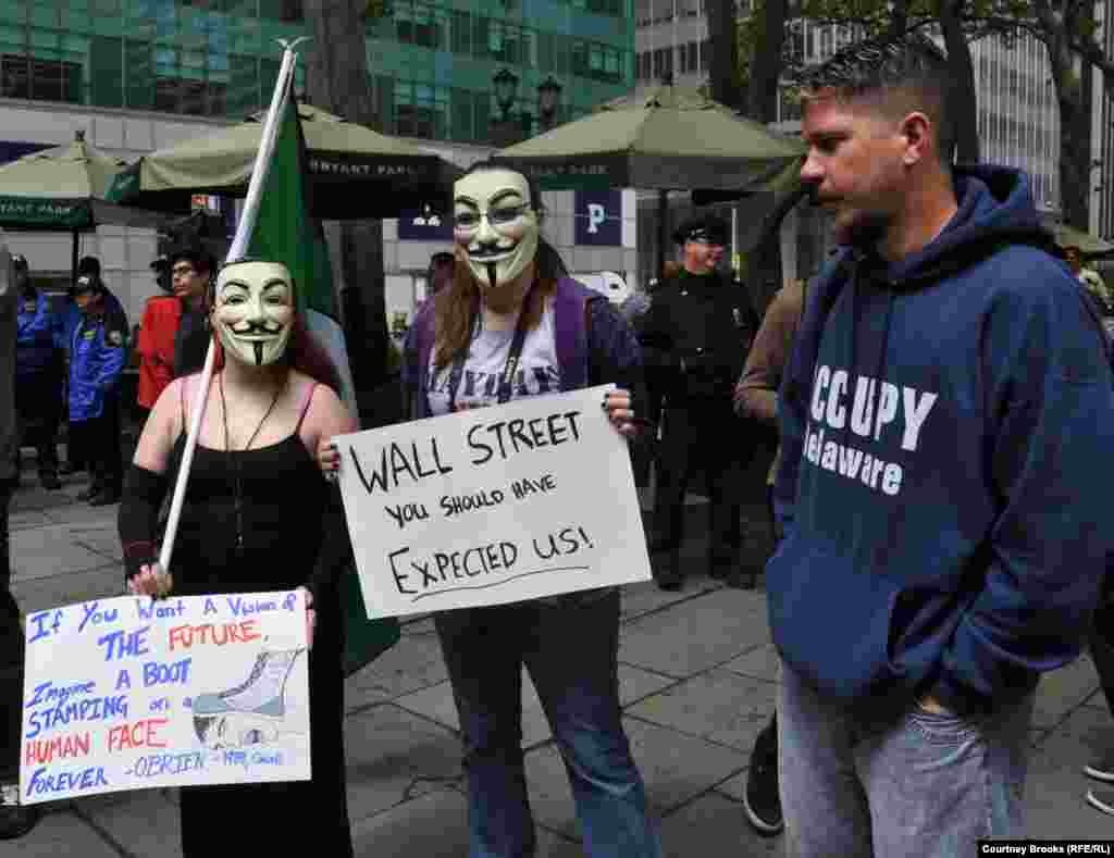 Three OWS activists protest at New York City&#39;s Bryant Park. Many protesters wore masks from the movie &quot;V For Vendetta,&quot; a dystopian thriller in which London is a police state.