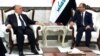 Iraqi parliament speaker Salim al-Jubouri (right) meets with Iraqi Prime Minister Haidar al-Abadi in Baghdad on September 27.