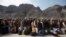 Afghan citizens wait to cross into their home country at the border post in Torkham on March 7. 